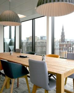 City view from floor to ceiling windows in a meeting room