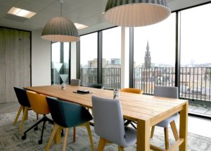 City view from floor to ceiling windows in a meeting room
